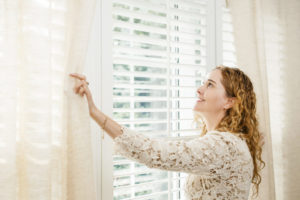 Smiling Woman Looking Out Window