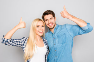 Attractive Cheerful Young Lovers Showing Thumbs Up