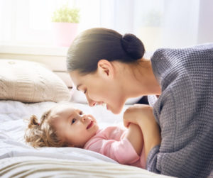 Happy Loving Family. Young Mother Are Playing With Her Baby Girl